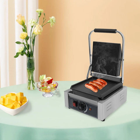 1800W Commercial Panini Press Grill Stainless Steel Electric Sandwich Maker cooking sausages on a table, showcasing adjustable temp control.
