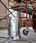 Silver MH200CVX 200,000 BTU Portable Outdoor Propane Heater in workshop setting, showing convection heating capability.