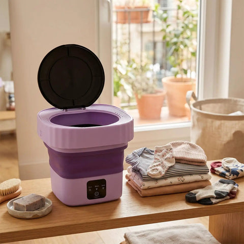 Top Slick 6 Liter Portable Mini Washer Folds Flat For Cramped Dorm Spaces shown open with clean laundry items nearby.