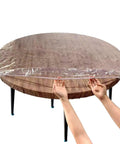 Crystal Clear Round Vinyl Tablecloth For 22 To 26 Inch Tables Heavy Duty Elasticized Fit With Elastic Edges Waterproof Non Yellowing Protection Transparent Plastic Cover That Shields Surfaces From Spills And Scratches on wooden table