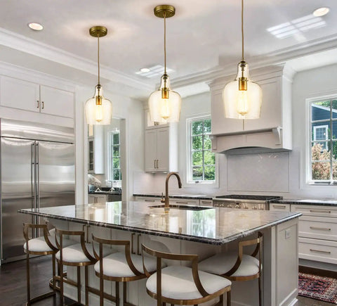 Lit Brushed Gold Pendant Light With Clear Glass Shade, Adjustable 59 Inch Cord in modern kitchen island setting