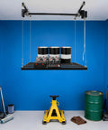 Hardcore Adjustable Overhead Garage Storage Rack With 300 Pound Capacity Rustproof Carbon Steel Ceiling Mount Hanger with tools and cans stored.