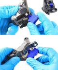 Hands using Six Piece Hydraulic Disc Brake Pad Spacer Set With Pro Grade Bleed Blocks to separate pads in bike calipers