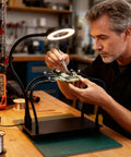 Man using Soldering Station With 5X Magnifying Light And Adjustable 4 Arm PCB Holder for assembly on wood workbench