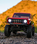 Redcat Racing Ascent 18 Scout II Brushless 4x4 One Eighteenth Scale RC Crawler with red body on rocky terrain