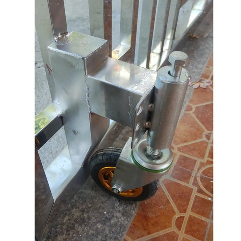 Friction Free 4 Inch Retractable Gate Casters With Heavy Duty Shock Dampening and Quick Flex Lifter For Dead Quiet Iron Gate Rolling Universal Swivel Wheels One Piece Graphite Gray mounted on a gate.