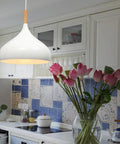 60 Watt Modern Elegance White Pendant Light Fixture for Kitchen and Dining Areas hanging in a kitchen with blue tiles.