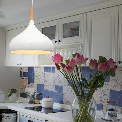 60 Watt Modern Elegance White Pendant Light Fixture for Kitchen and Dining Areas hanging in a kitchen with blue tiles.