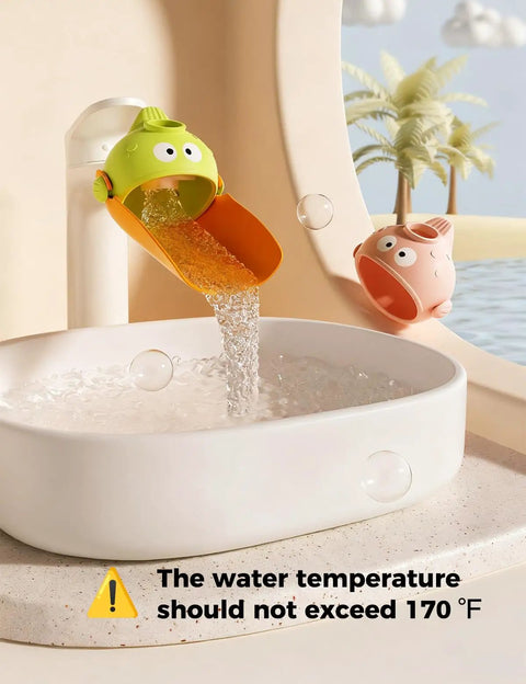 Handy Dandy Silicone Faucet Extender For Toddlers Smooth Sink Reach Helper, green fish design attached to faucet pouring water.