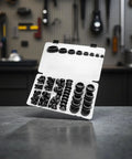 125 Pcs Black Silicone Plugs Kit Assorted 8 Sizes For Round Holes Snap Locking Rubber Stopper Seals With Storage Case Protects Surfaces From Drips. open case with assorted black silicone plugs