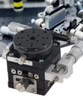 Close-up of Three Axis Manual Linear Stage 40x40mm with fine adjustment knobs in optical lab setup.