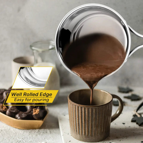 1 Quart Stainless Steel Saucepan With Glass Lid pouring chocolate into mug, showing rust free, easy pouring, durable small sauce pot