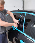 Person applying Automotive Masking Tape Set For Curves And Fine Edges, Pro Grade High Temperature Vinyl Tape to car windows
