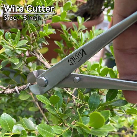 Close-up of a wire cutter from the 6 Piece Bonsai Tool Set Pro Grade With Concave Cutter, 210mm, trimming a plant branch.