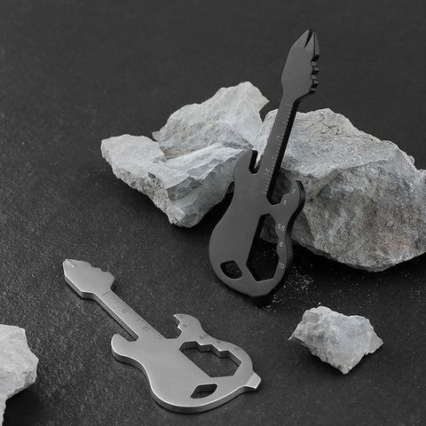 Stainless Steel Multitool Keychain With Bottle Opener Screwdriver Imperial And Metric Ruler And Bike Spoke Key on rocks