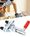 Double Head Push Pull Toggle Clamp Securely Locks Welding, Saws And Molds For Rock Solid Build Quality And Quick Release Clamping Action On Any Shop Job close-up with red handle and rubber heads.
