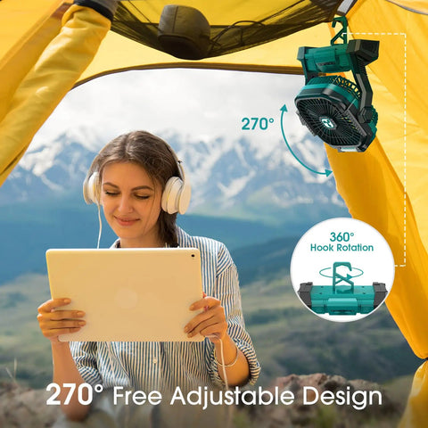 Rechargeable Portable Fan With 20000mAh Battery hanging in a tent, 270-degree rotation feature, with person using tablet outdoors.