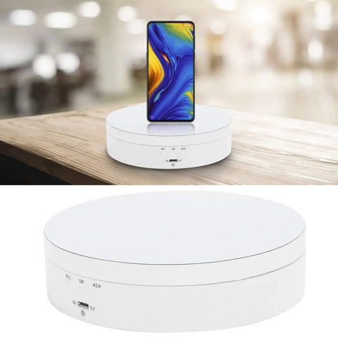 Electric Rotating Display Stand For Jewelry Watch Cosmetics And Toys 3 Speeds 360 Turntable With USB Charging Port ABS Material auto spin holder with smartphone on a wooden table