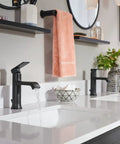 Genta LX Modern 6.8 Inch Matte Black Towel Bar in a chic bathroom setting, coordinating with matte black faucets.