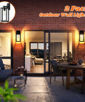 Built Tough 2 Pack Waterproof Outdoor Wall Lanterns, Rust Resistant Black Sconces With Shatterproof Clear Glass mounted on brick wall.