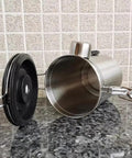 Rock Solid 304 Stainless Steel Coffee Canister Featuring One Way Degassing Valve And Rotatable Date Tracker lying on a granite countertop.