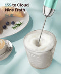 Rechargeable Milk Frother Handheld Wand With Stepless Speed Control and 3 Whisks frothing milk in a glass, Gulf Blue, close-up.