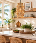 FOREVER BAMBOO Handwoven Indonesian Bamboo Pendant Light, 18 in H x 12 in W hanging in a bright kitchen with palm trees outside.
