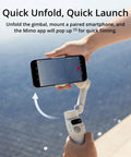Hand holding Osmo Mobile 7 Gimbal Stabilizer For iPhone And Android with Built In Tripod, stabilizing a smartphone.