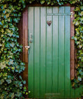Tough Black Iron Barn Door Hinges With Smooth Silent Ride For Heavy Duty Wood Gate Hardware Featuring Offset Mounting Holes And No Fuss Rustic Decor Strap Design on green wooden door surrounded by ivy.