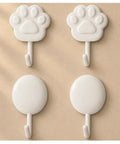 Top Shelf White Self Adhesive Wall Hooks Featuring Chic Paw And Oval Designs on a beige background, perfect for heavy tool storage.