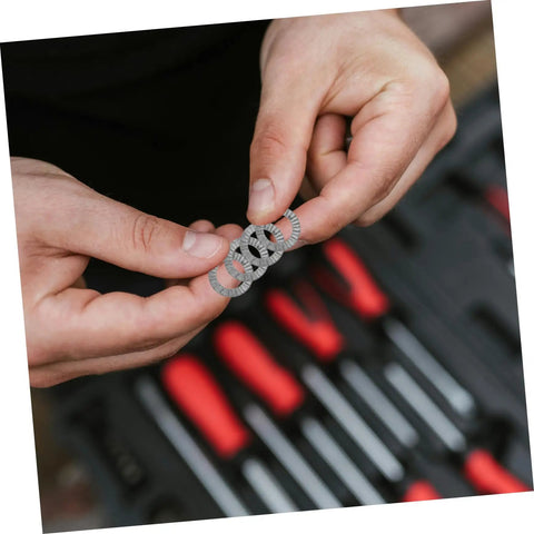 Person holding Top Shelf Tapered Lock Washers For M10 Manganese Steel from 20 Pack in hand, showing grip and design.