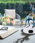 Badass Electric Powered 360 Motorized Tumbler Display Stand with blue deer figurine, white base, and steady rotation for displays.