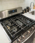 Stainless Steel Stove Gap Covers 2 Pack installed between stove and counter, heat resistant kitchen gap filler for appliances.