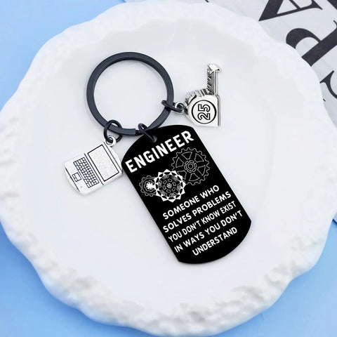 Engraved Engineer Keychain Gift For Men And Students, Cool Graduation Present For Engineers, Electrical Engineering Lovers Gift, Engineer Quote Keychain, Problem Solvers Pride, Perfect Everyday Accessory with charms on white plate.