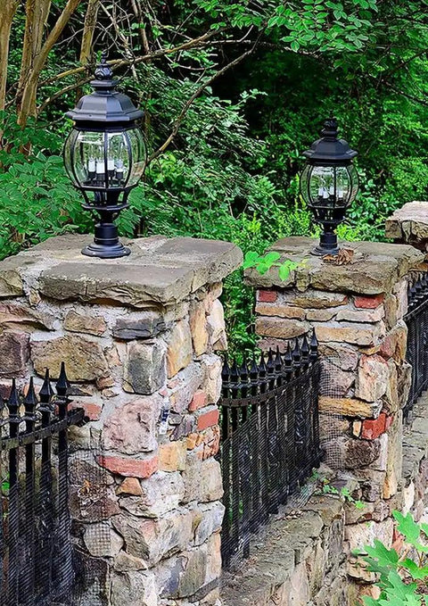 Outdoor Onion Lantern In Black Finish, 6.5 Inch Width By 21.25 Inch Height on stone pillars along a garden pathway