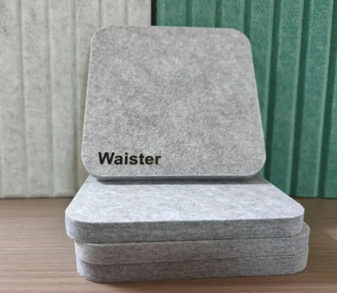Snag This 4 Pack Of Polyester Fiber Acoustic Panels Self Adhesive Sound Proof Tiles 0.4 Inch Thick stacked gray felt tiles on wood.