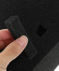 Hand holding black foam piece removed from Black Foam Liner Packing Inserts For Protection And Impact Resistance.