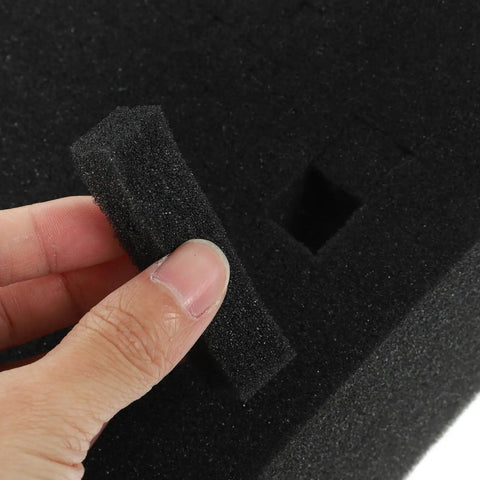 Hand holding black foam piece removed from Black Foam Liner Packing Inserts For Protection And Impact Resistance.
