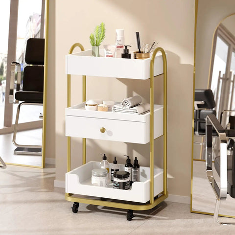 Salon Trolley Cart With Three Trays And One Drawer Mobile Hair Styling Station On Two Lockable Wheels Pro Grade Esthetician Cart For Beauty Spa And Barbershop Large White Storage Cabinet with products displayed in a salon setting.