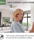 Woman adjusting thermostat with 42 Inch Indoor Ceiling Fan With LED Light Kit, Matte Black, 5 Blade in living room