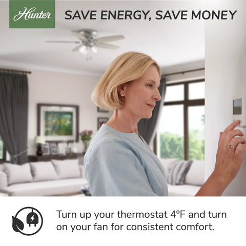 Woman adjusting thermostat with 42 Inch Newsome Premier Bronze Low Profile Ceiling Fan With LED Light Kit in living room.