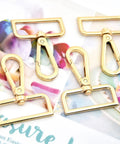 Heavy Duty Gold Zinc Alloy Swivel Lobster Clasps With Push Gate Snaphooks on artwork background, showcasing versatile use.