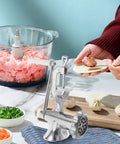 Manual Corn And Grain Mill With High Hopper Cast Iron Hand Crank For Domestic Use on a countertop making dumplings