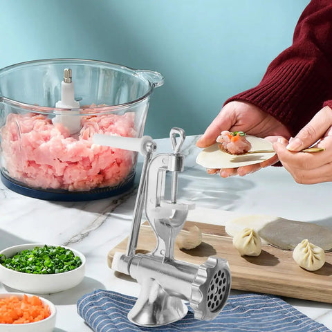Manual Corn And Grain Mill With High Hopper Cast Iron Hand Crank For Domestic Use on a countertop making dumplings