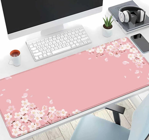Pink Cherry Blossom Desk Pad 31.5 By 11.8 Inches With Non Slip Rubber Base Large Gaming Mouse Pad on a desk with computer and accessories.