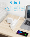 Super Slick Flat Plug Power Strip With 5 Ft Extension Cord 6 Widely Spaced Wall Outlets Plus 3 Fast Charge USB Ports For Hiding Behind Furniture Setup White 2 Pack Bundle on a desk with phone charging.