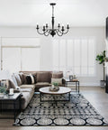 Black 6 Light Farmhouse Chandelier with Rustic Industrial Vibe hanging in elegant living room, height adjustable pendant