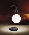 Floating Moon Lamp With Built In Qi Wireless Charger Modern Levitating Light With Touch Control in a dimly lit room