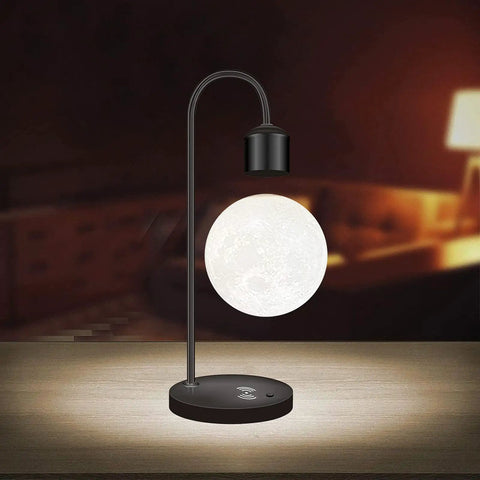 Floating Moon Lamp With Built In Qi Wireless Charger Modern Levitating Light With Touch Control in a dimly lit room