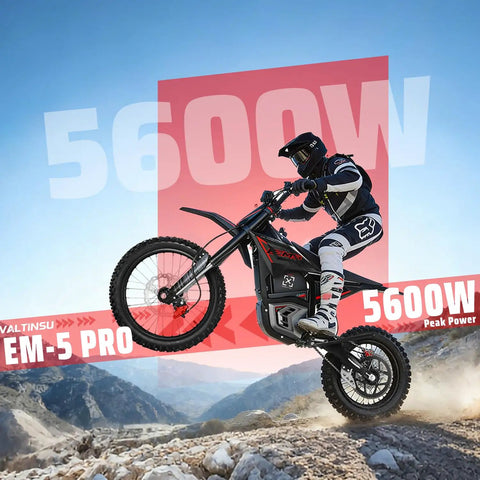 Rider on EM5 Pro 60V Electric Dirt Bike With Light And Display Off Road Motorcycle 5600W Power in rugged terrain, mid-jump.